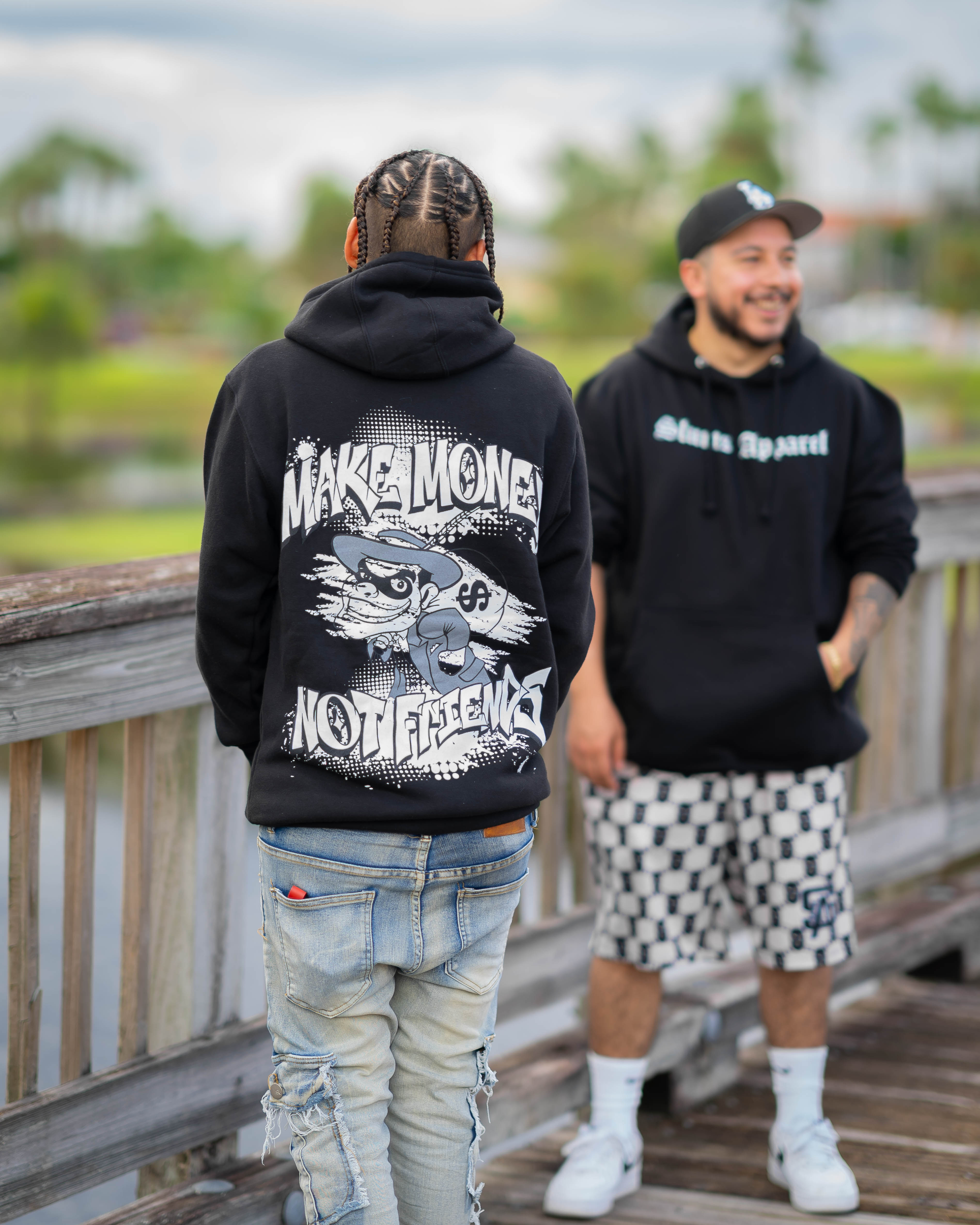 Model wearing A black graphic hoodie make money not friends