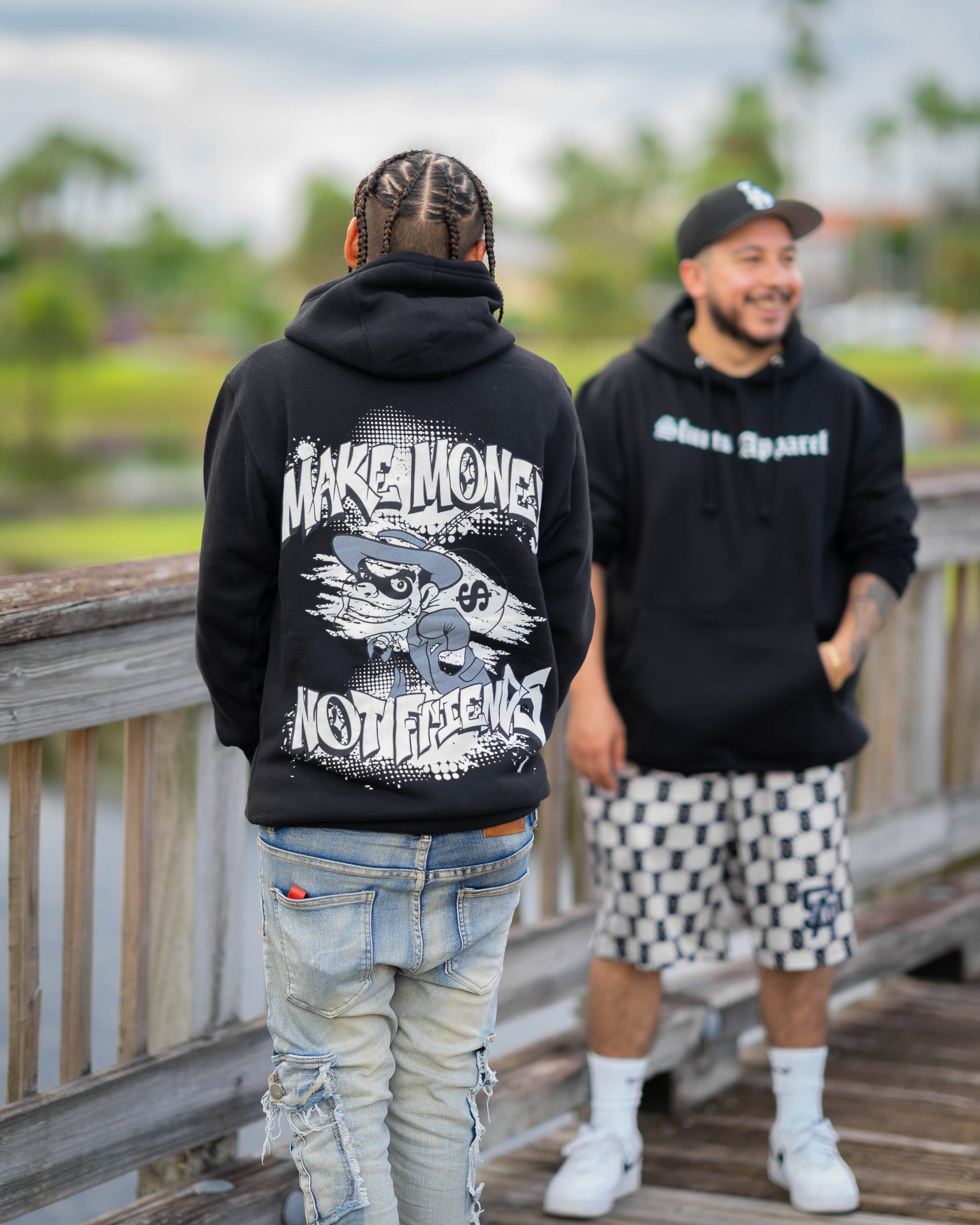 Model wearing A black graphic hoodie make money not friends 
